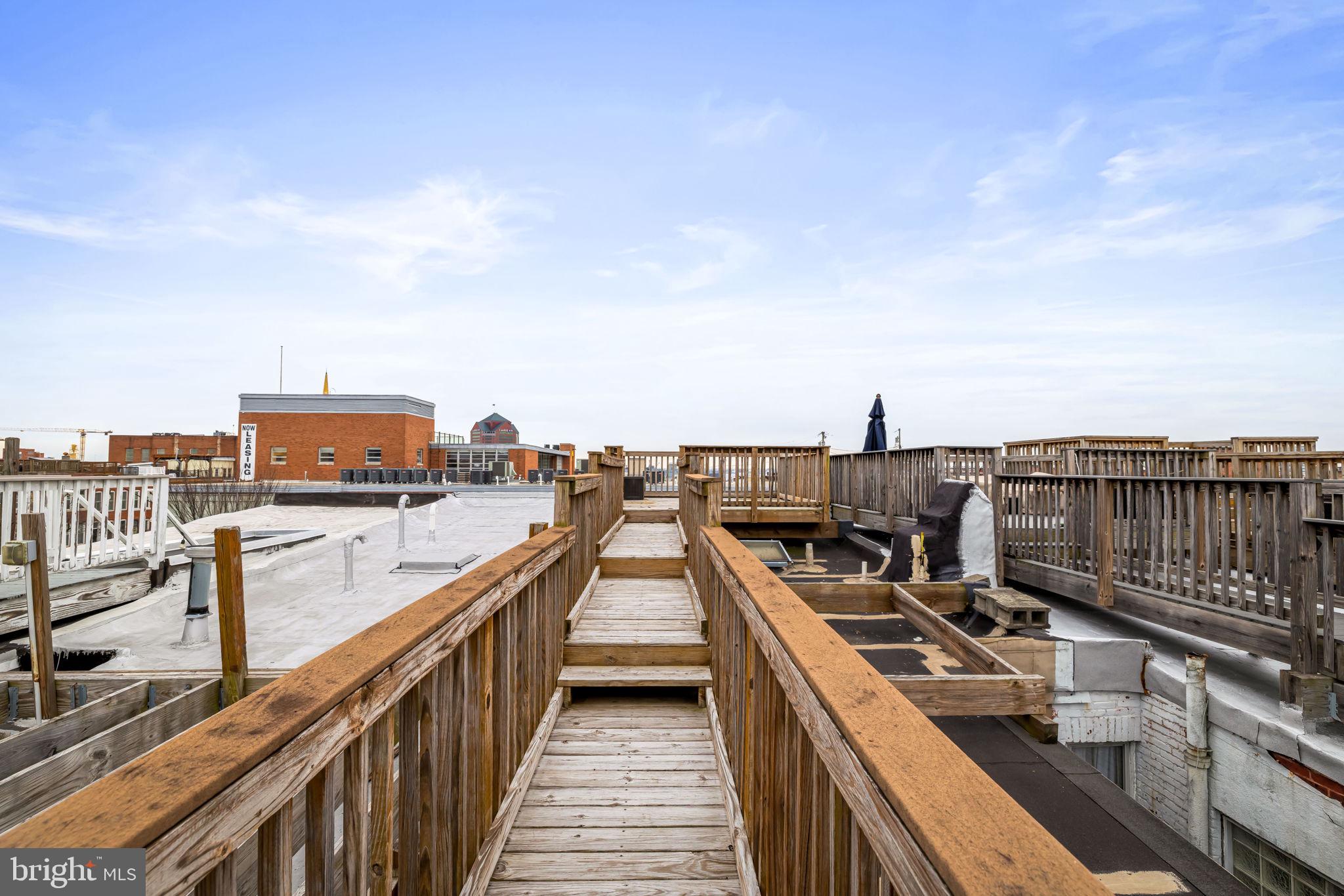 3116 Hudson Street Baltimore, MD 21224 - Photo 32 of 39 a view of a roof deck with two chairs and a stove