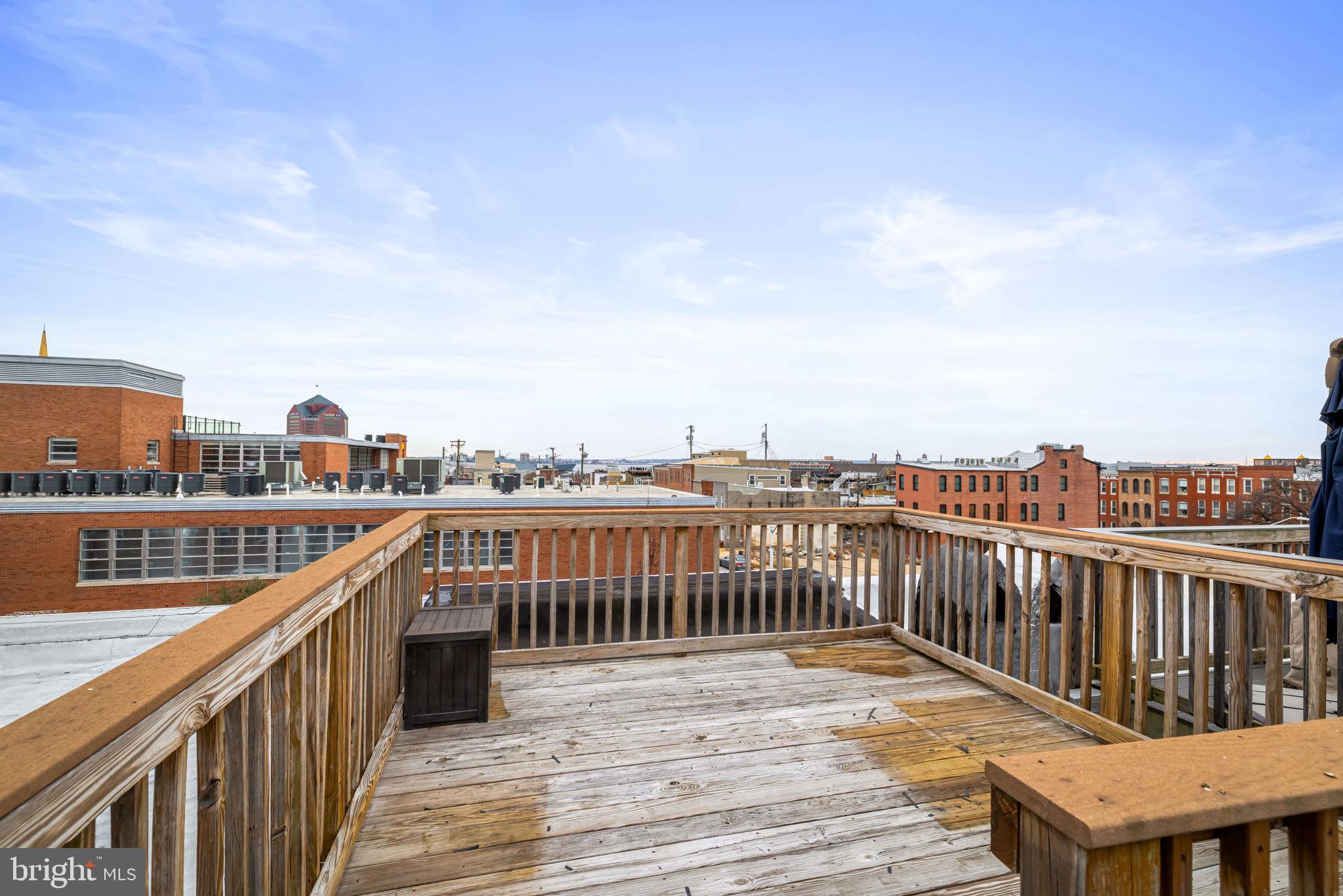 3116 Hudson Street Baltimore, MD 21224 - Photo 33 of 39 a view of roof deck with two chairs and wooden floor