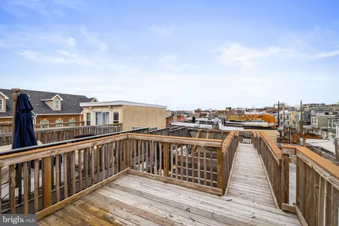 a view of a balcony with wooden floor and city view