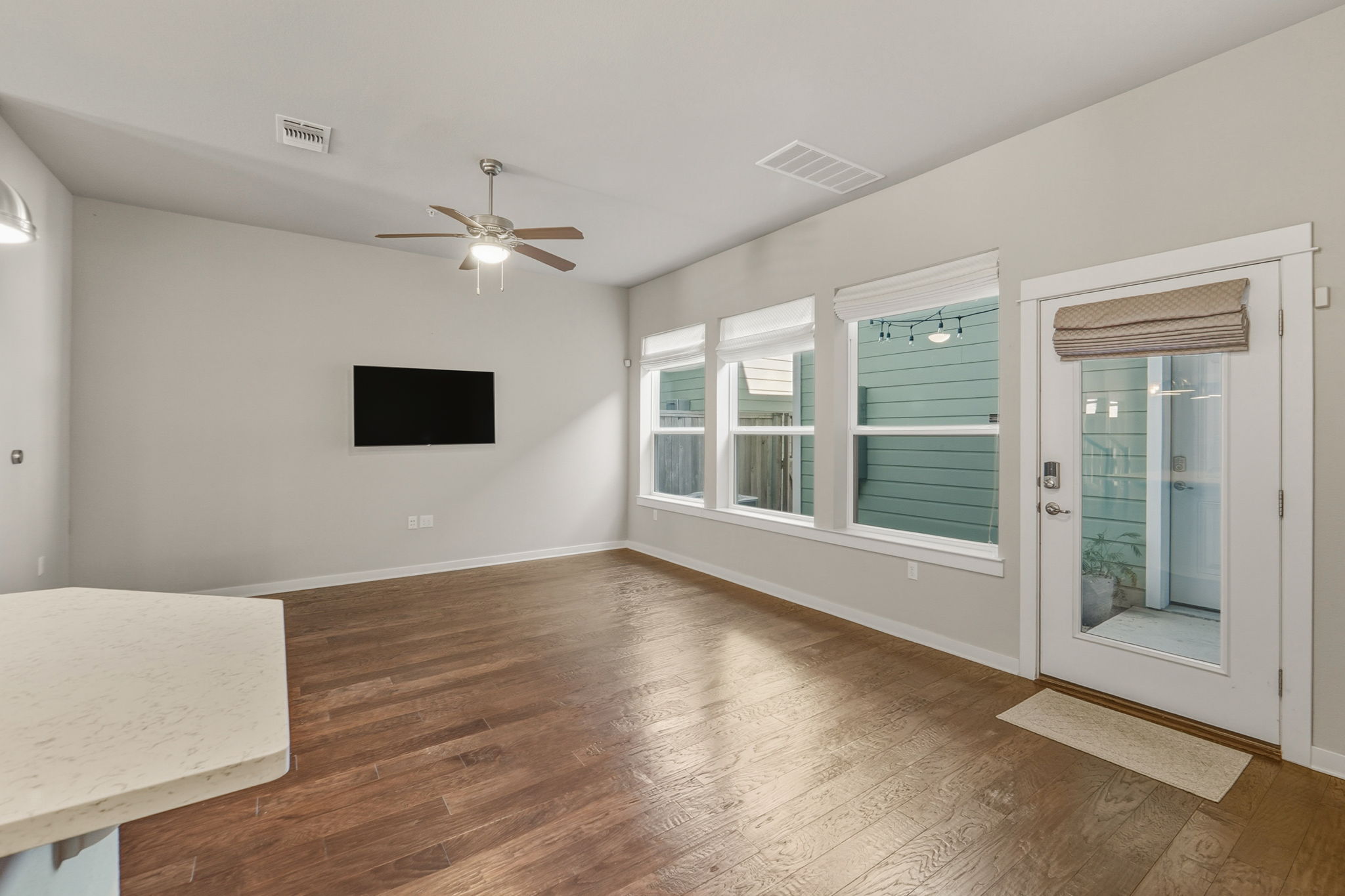 3919 Vaughan Street Austin, TX 78723 - Photo 15 of 40 An inviting common area features warm wood flooring and ample natural light through large windows.