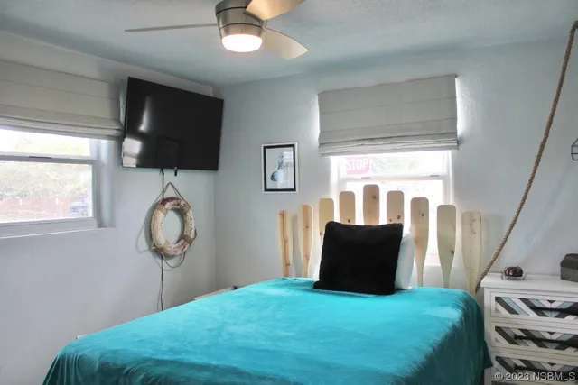 a bedroom with a bed and flat screen tv