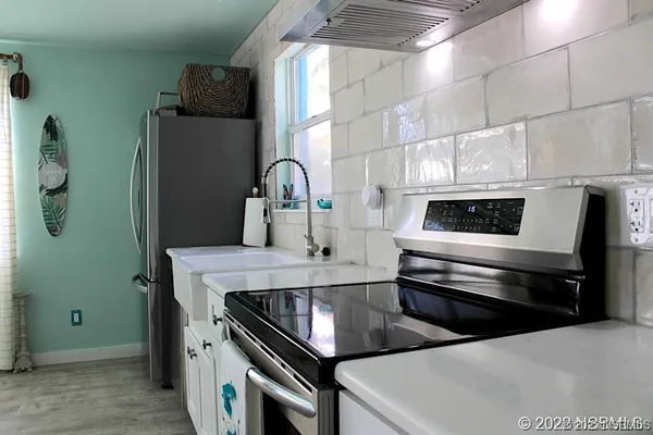 a kitchen with stainless steel appliances and white cabinets
