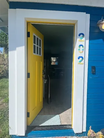 a view of a hallway with wooden floor and closet