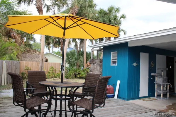 a view of an outdoor space with furniture and umbrella