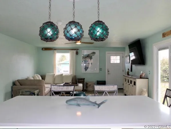 a living room with lots of furniture and chandelier
