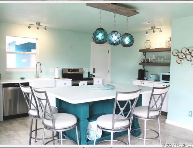 a view of a dining room with furniture and chandelier