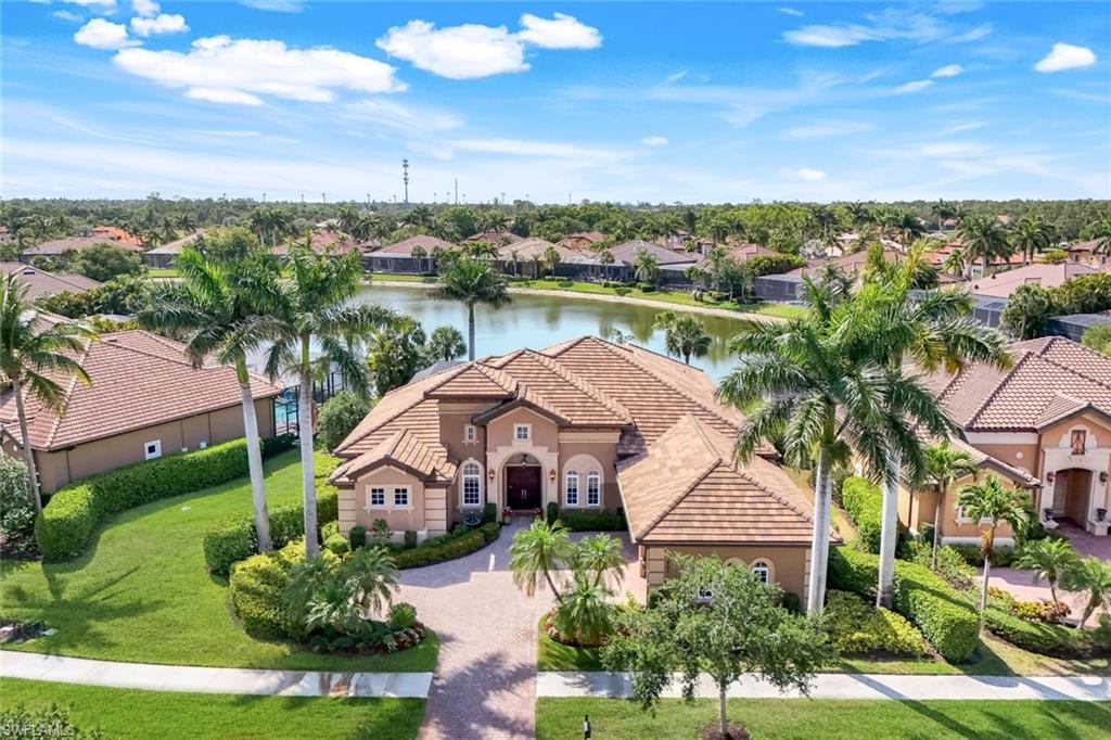 8993 Crooked Stick Court Naples, FL 34113 - Photo 1 of 24 a view of a city from a lake