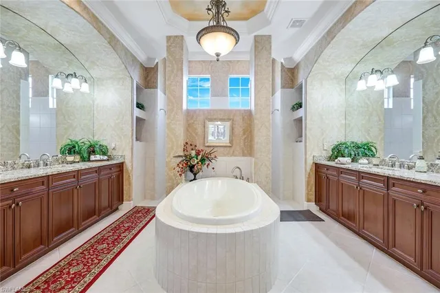 a spacious bathroom with a double vanity sink and a mirror