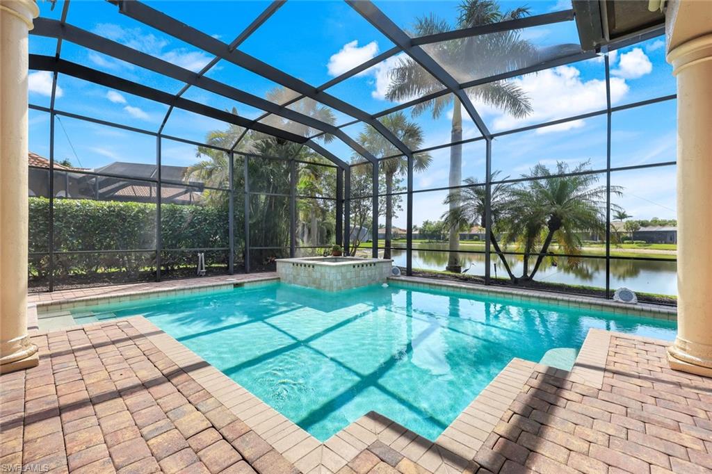 8993 Crooked Stick Court Naples, FL 34113 - Photo 17 of 24 a view of a swimming pool with a patio