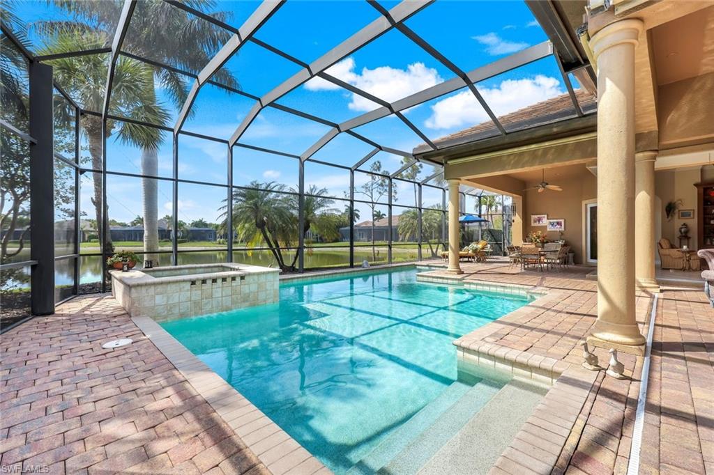 8993 Crooked Stick Court Naples, FL 34113 - Photo 20 of 24 a view of a swimming pool with a patio