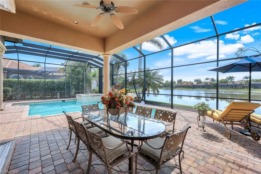 8993 Crooked Stick Court Naples, FL 34113 - Photo 21 of 24 a view of a patio with a table chairs and a table