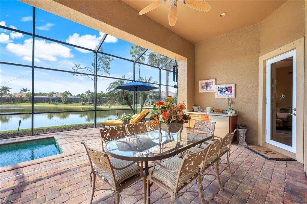 8993 Crooked Stick Court Naples, FL 34113 - Photo 22 of 24 a dining room with furniture and a floor to ceiling window