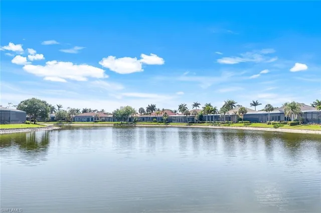 an aerial view of residential houses with outdoor space and ocean view