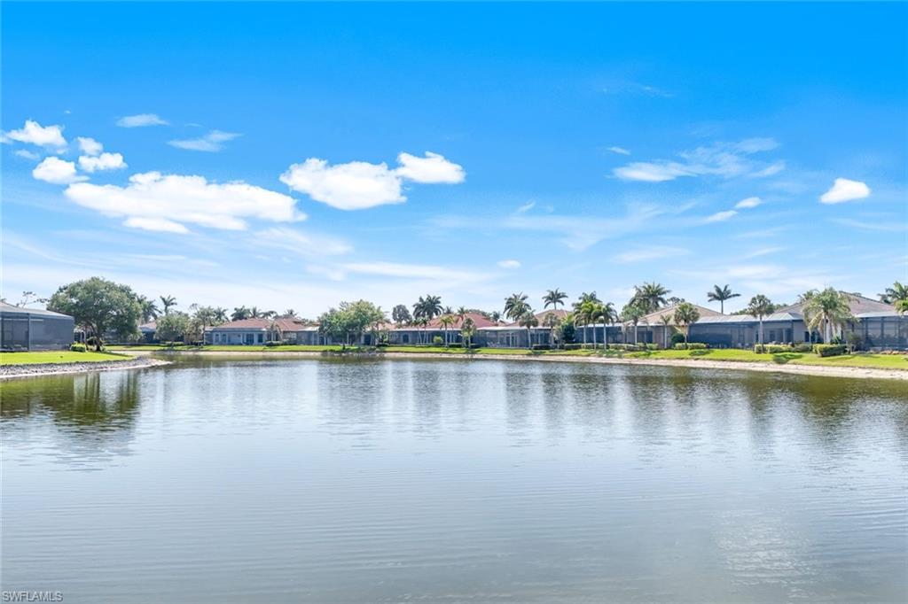 8993 Crooked Stick Court Naples, FL 34113 - Photo 23 of 24 a view of a lake with houses in the back