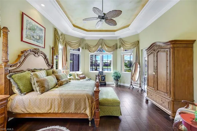 a spacious bedroom with a bed a window and a chandelier