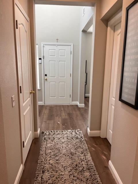 4184 Ivory Lane Turlock, CA 95382 - Photo 8 of 11 view of a hallway with wooden floor and a bathroom