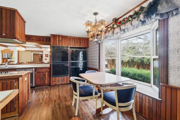 a dining room with furniture and a kitchen view