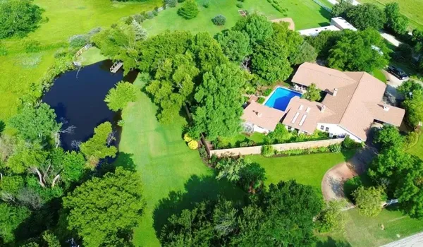 an aerial view of a house with garden space and street view