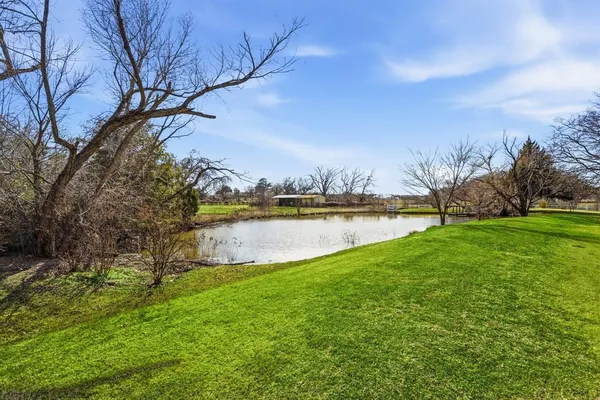 a view of a lake with houses in the back