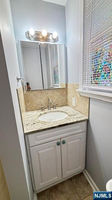 760 Hamilton Street, Unit 1 Harrison, NJ 07029 - Photo 18 of 23 a bathroom with a granite countertop sink and a mirror