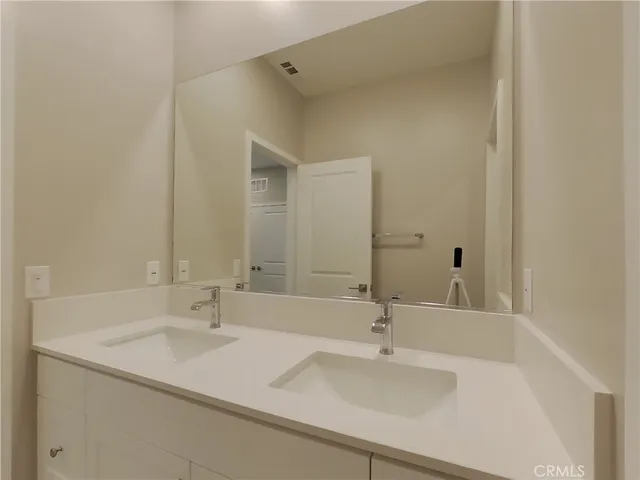 a bathroom with a sink and a large mirror