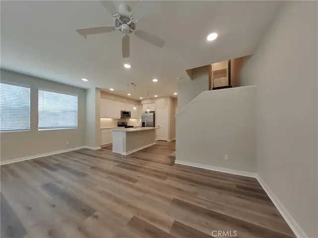 a view of empty room with wooden floor and window