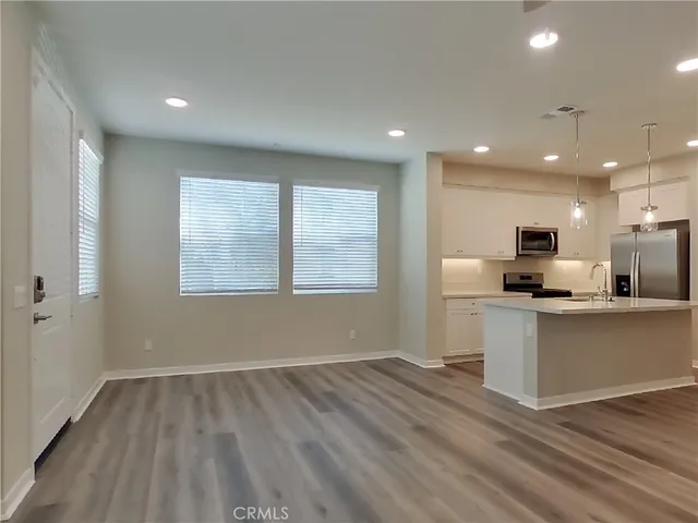 a view of kitchen with stainless steel appliances refrigerator oven and cabinets
