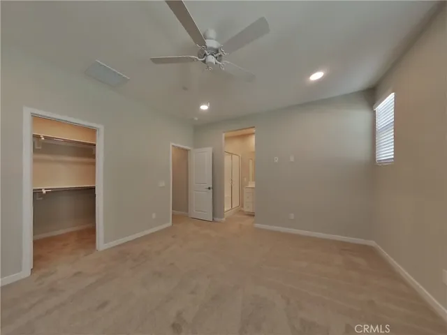 an empty room with fan and a ceiling fan