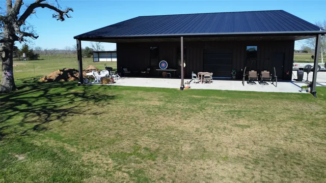 a view of a house with backyard porch and furniture