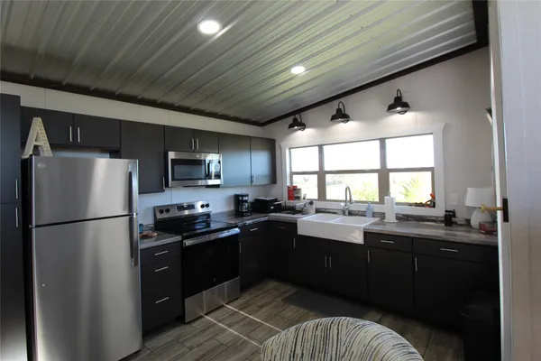 a kitchen with refrigerator and cabinets