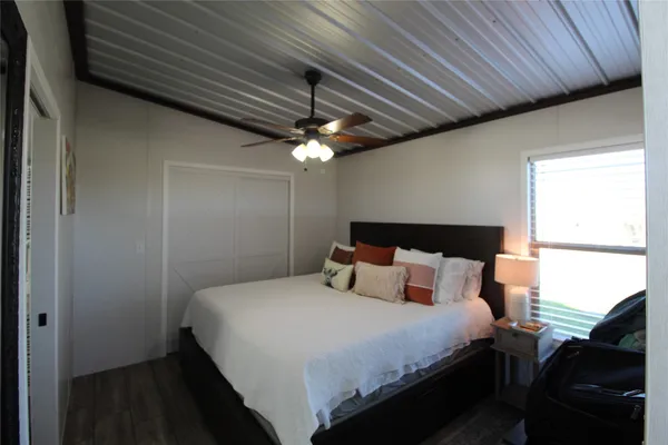 a bedroom with a bed and a chandelier