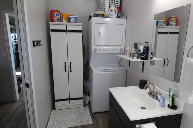 a bathroom with a sink and a refrigerator