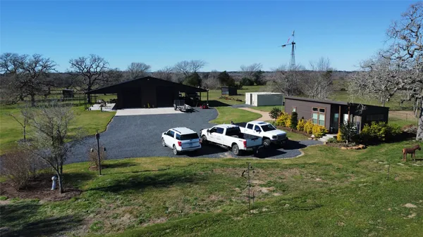 a view of a patio with table and chairs under an umbrella