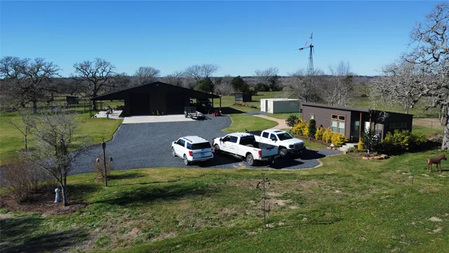 a view of a patio with table and chairs under an umbrella