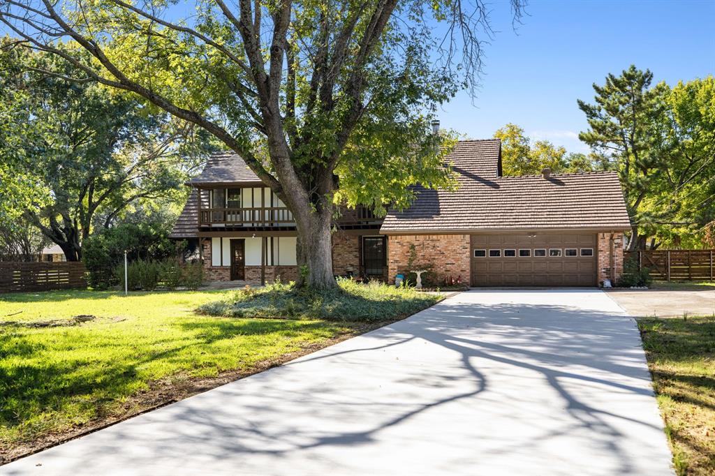212 Magic Lane Sunnyvale, TX 75182 - Photo 1 of 22 a house that has a tree in front of it