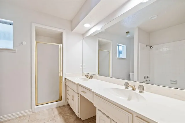 a bathroom with a double vanity sink mirror and double