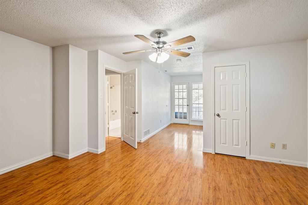 212 Magic Lane Sunnyvale, TX 75182 - Photo 17 of 22 a view of an empty room with window and wooden floor