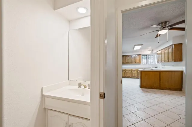 a bathroom with a sink a vanity and a mirror