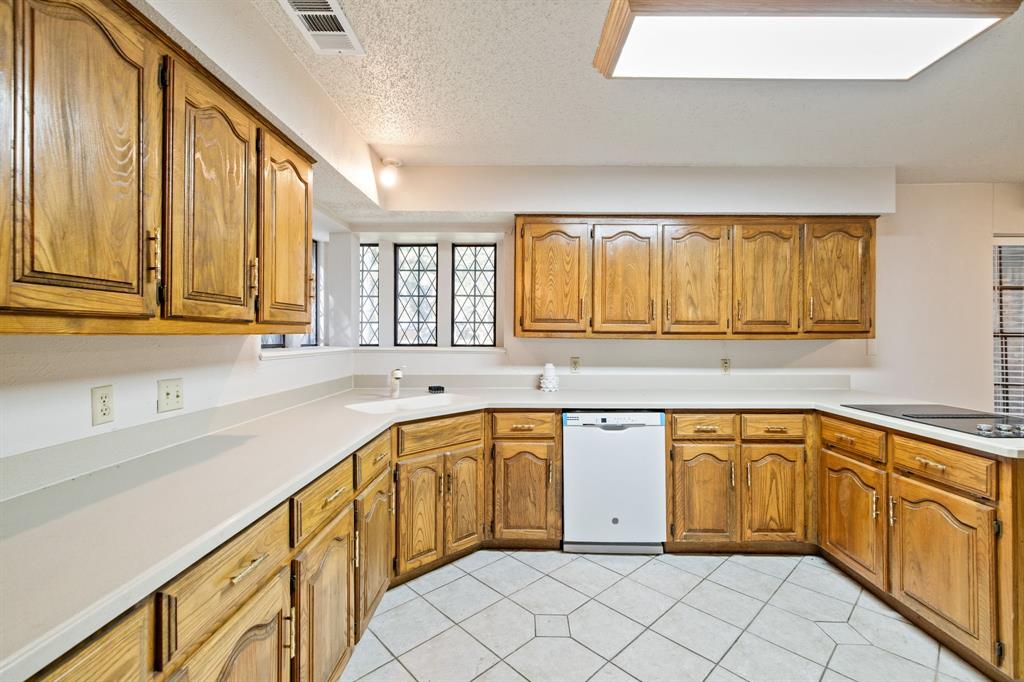 212 Magic Lane Sunnyvale, TX 75182 - Photo 2 of 22 a kitchen with a sink stove and cabinets