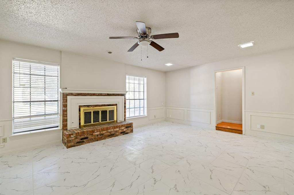 212 Magic Lane Sunnyvale, TX 75182 - Photo 3 of 22 an empty room with fireplace fan and windows