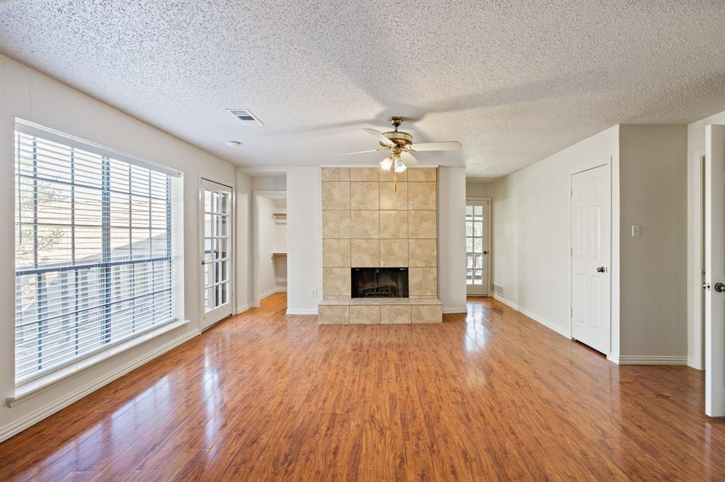 212 Magic Lane Sunnyvale, TX 75182 - Photo 4 of 22 wooden floor fireplace and windows in an empty room