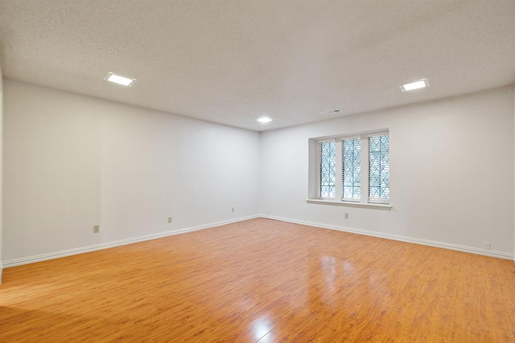 212 Magic Lane Sunnyvale, TX 75182 - Photo 10 of 22 an empty room with wooden floor and windows