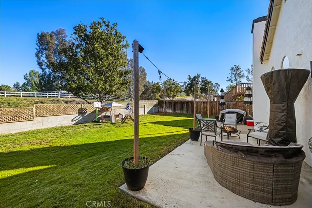 a view of a swimming pool with a patio and a yard