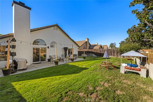 a view of a house with garden and sitting area