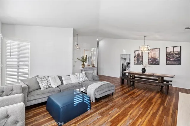 a living room with furniture a rug and a wooden floor