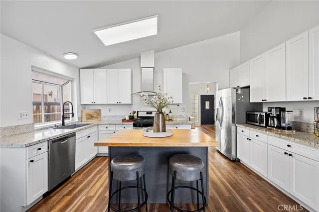 a kitchen with appliances a sink and cabinets