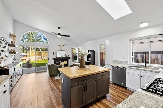 a large kitchen with a counter space a sink appliances and cabinets