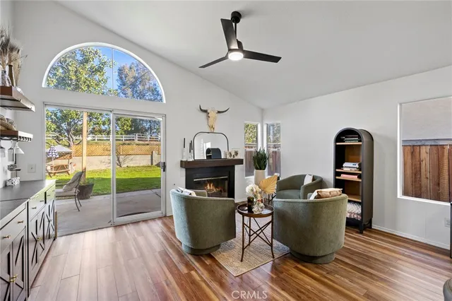 a living room with furniture a rug and a large window