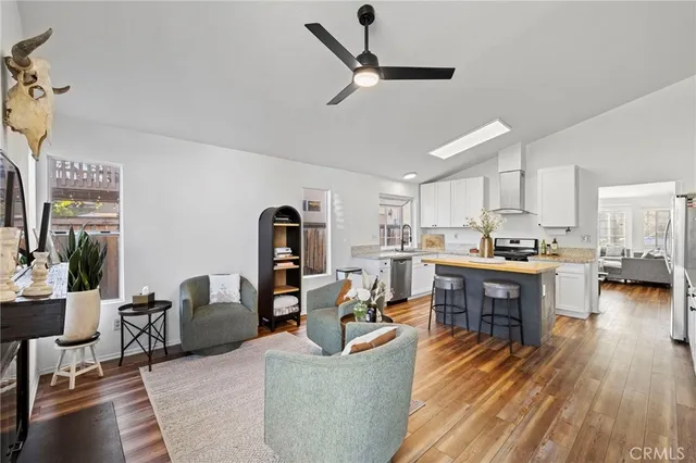 a living room with furniture and kitchen view
