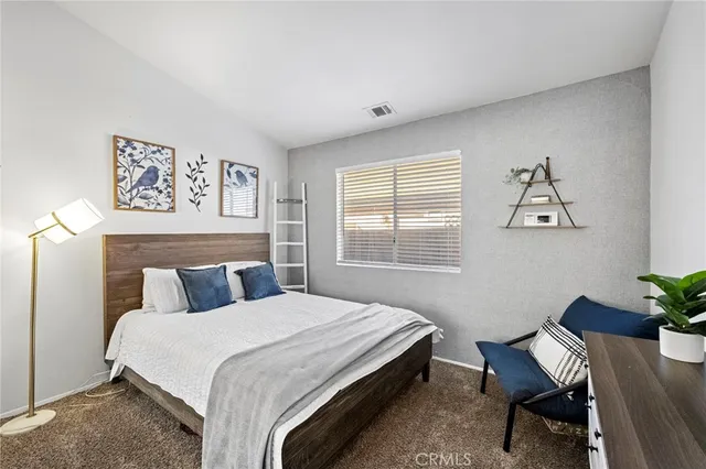 a bedroom with a bed and a desk